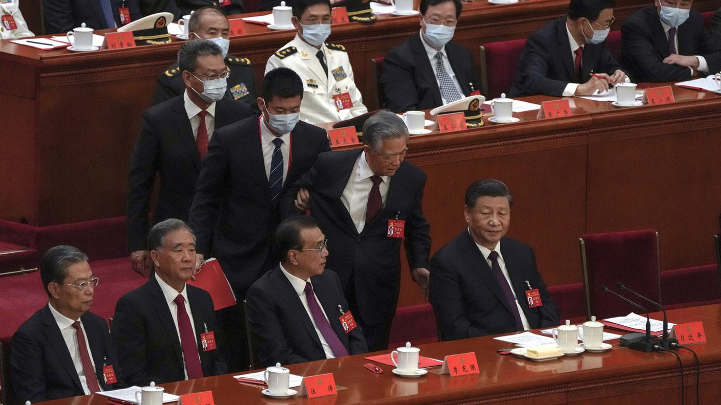 L'ex presidente cinese Hu Jintao cerca di parlare con Xi Jinping mentre viene portato fuori dal Congresso del PCC