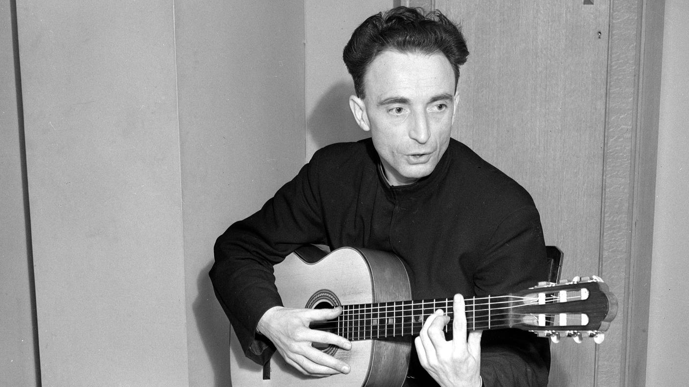 Father Aime Duval guitar playing