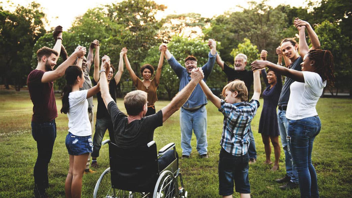 Group of people holding hand together in the park