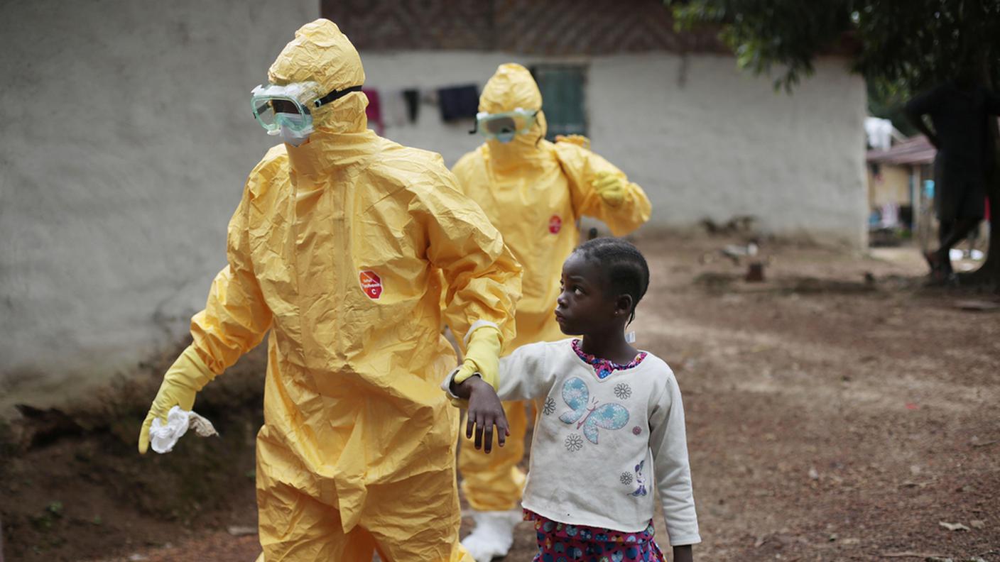 Liberia: personale sanitario accompagna una bimba che mostra i sintomi del virus in ospedale