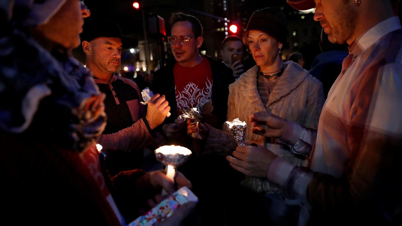 Un gruppo di persone si raccoglie in memoria delle vittime in California