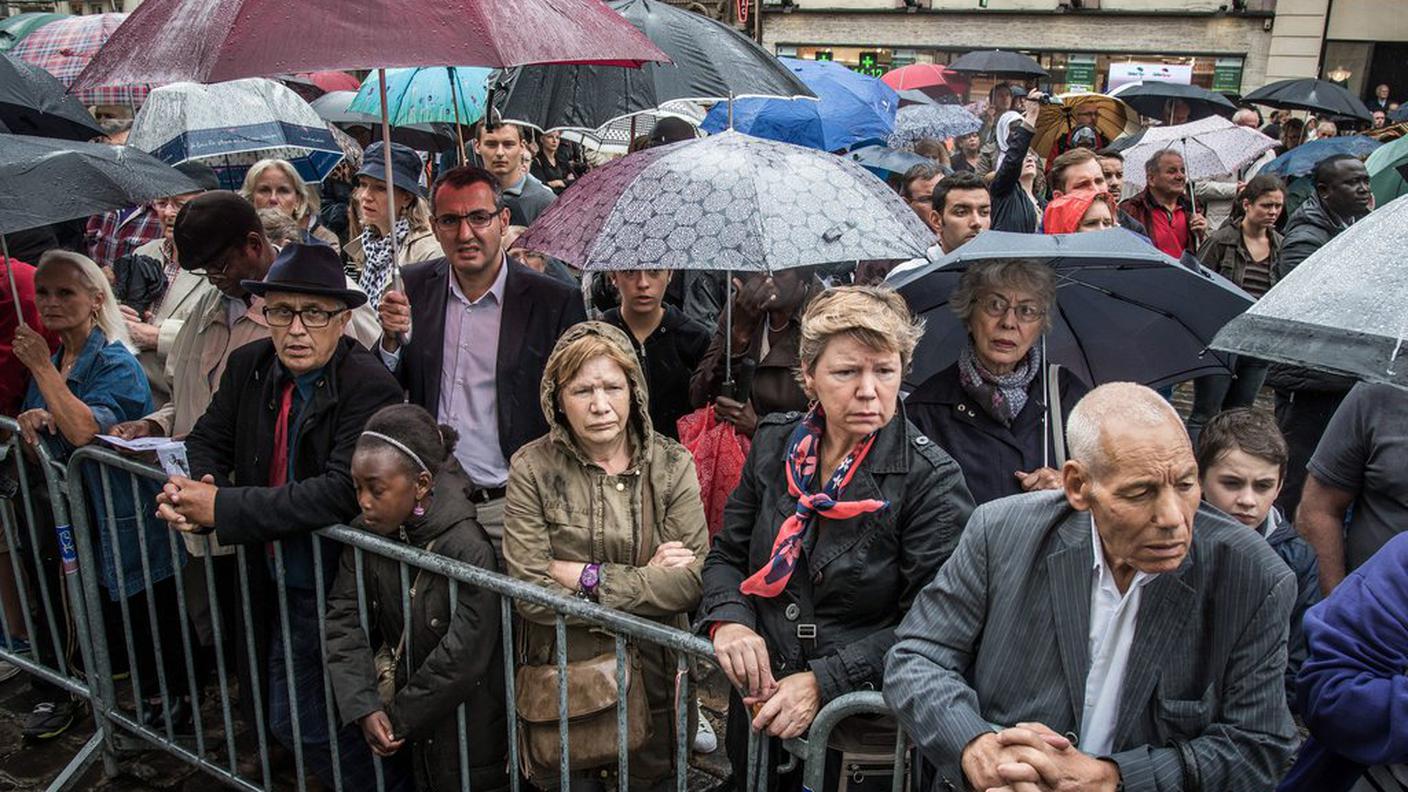 Le numerose persone presenti davanti alla cattedrale di Rouen non si sono fatte scoraggiare dalla pioggia