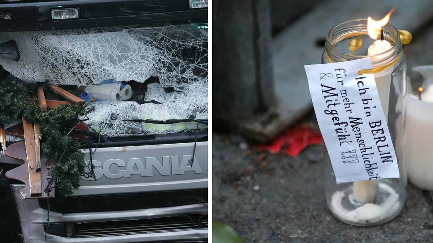 Il camion e i primi omaggi per le vittime