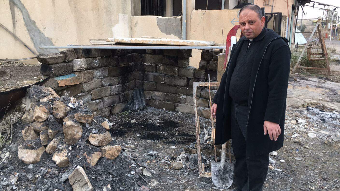Padre Paolo, sacerdote aramaico-caldeo davanti al suo "presepe" nella città distrutta 