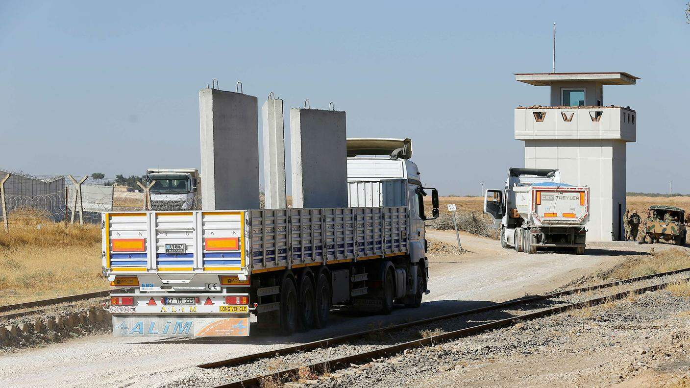 Alcuni autocarri trasportano sezioni del muro sul confine tra Siria e Turchia