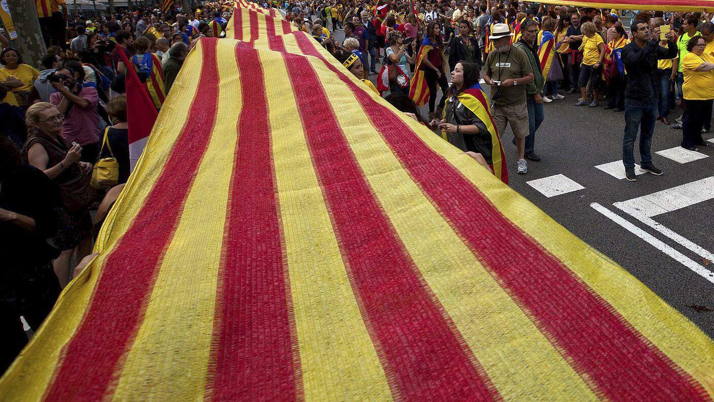 Una gigantesca bandiera catalana, portata in piazza dai sostenitori dell'indipendenza da Madrid