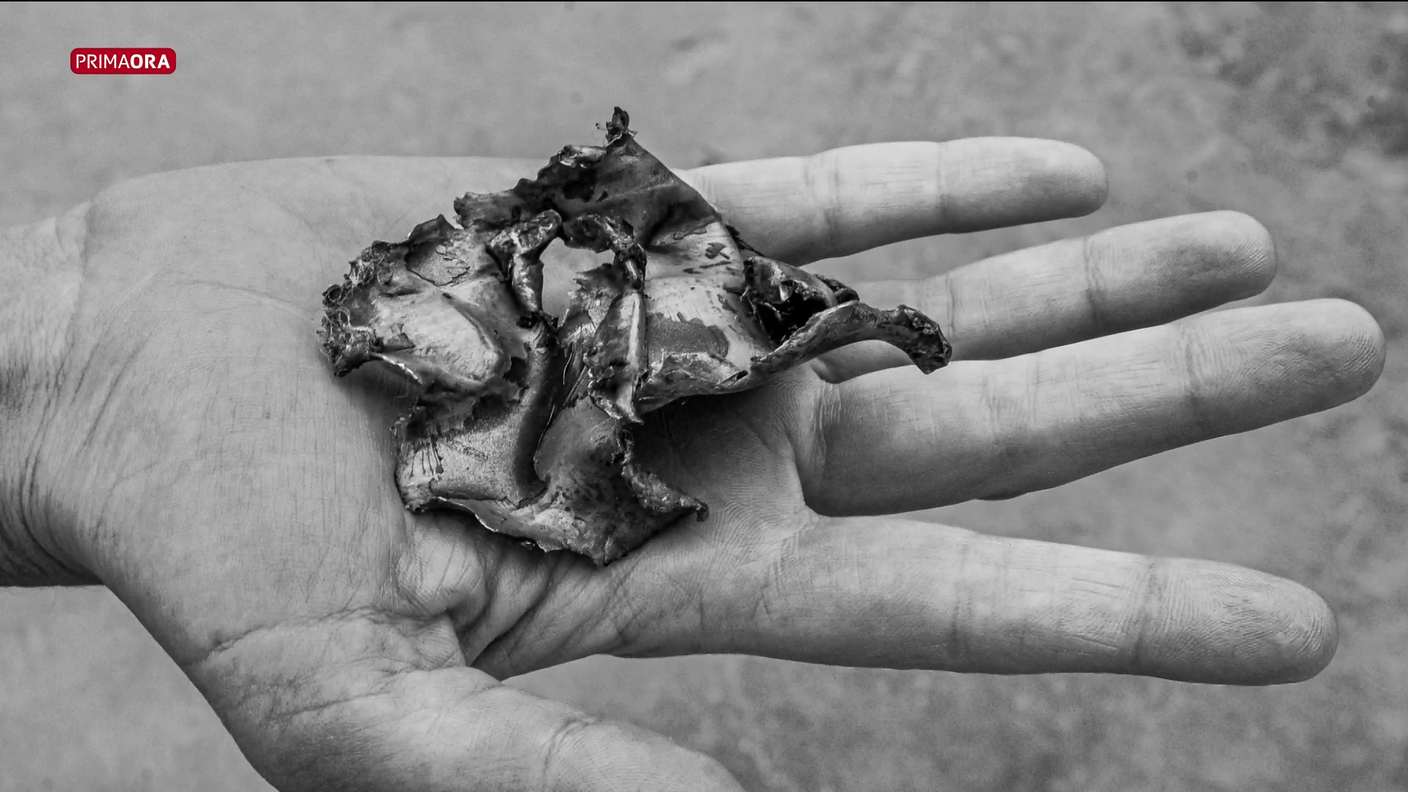 La mano di un bambino e la scheggia di ordigno bellico 