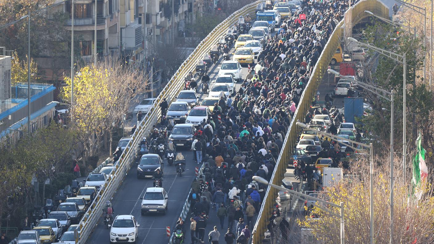 I manifestanti marciano nel centro di Teheran, in Iran, lunedì 29 dicembre 2025.