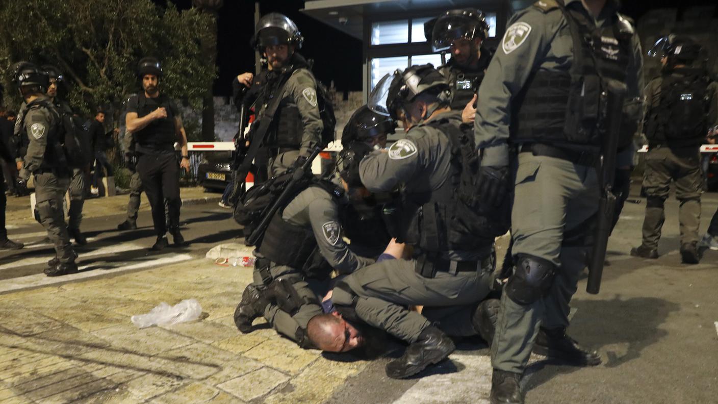 Agenti della polizia israeliana fermano un manifestante palestinese