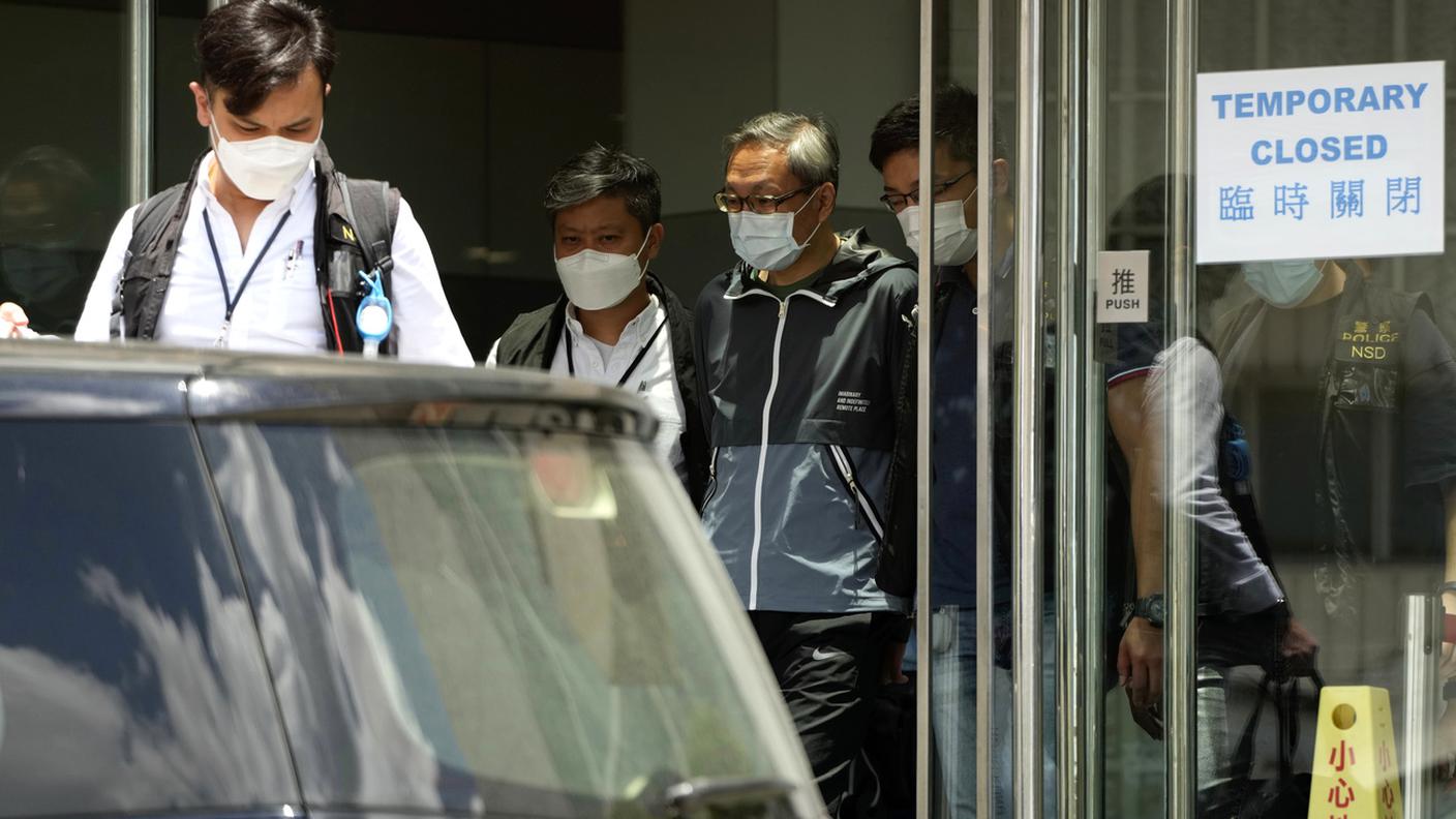 I responsabili del quotidiano, scortati dalla polizia all'esterno della sede del giornale, dopo gli arresti di stamani