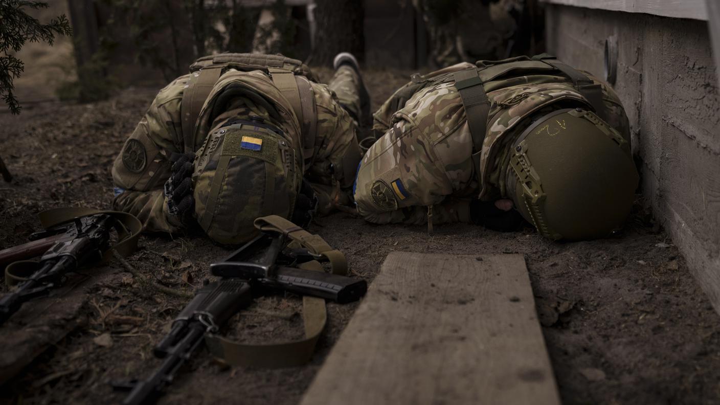 Due soldati ucraini si riparano dal fuoco russo a Irpin, alla periferia di Kiev