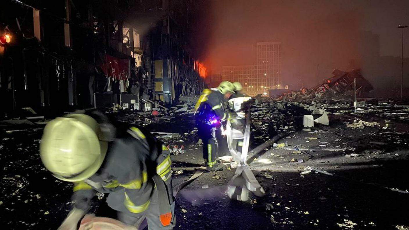 Pompieri al lavoro al centro commerciale colpito dal bombardamento a Kiev