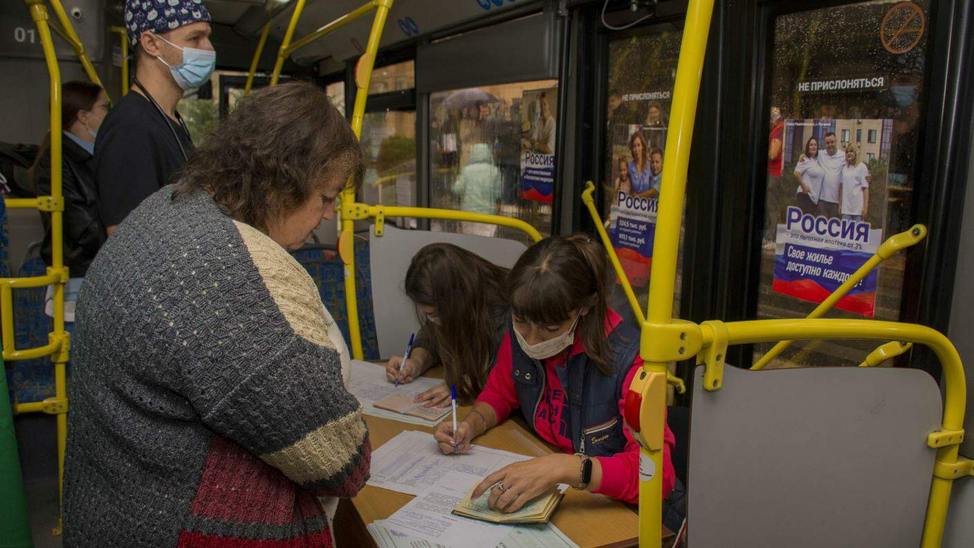 Un seggio elettorale organizzato senza nessuna privacy all'interno di un autobus a Luhansk