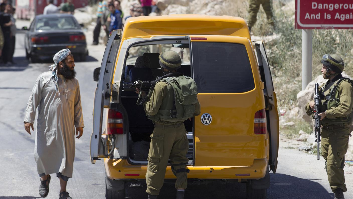 Soldati israeliani controllano un veicolo a Hebron, in Cisgiordania 