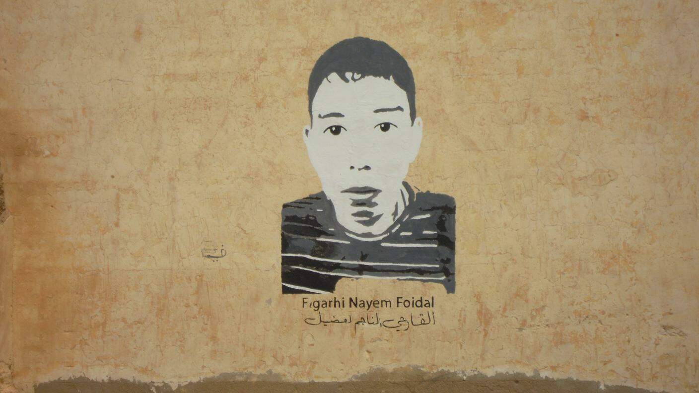 L'immagine di Najem El Garhi, la più giovane vittima della repressione a Gdeim Izik, su un muro di El Aaiun