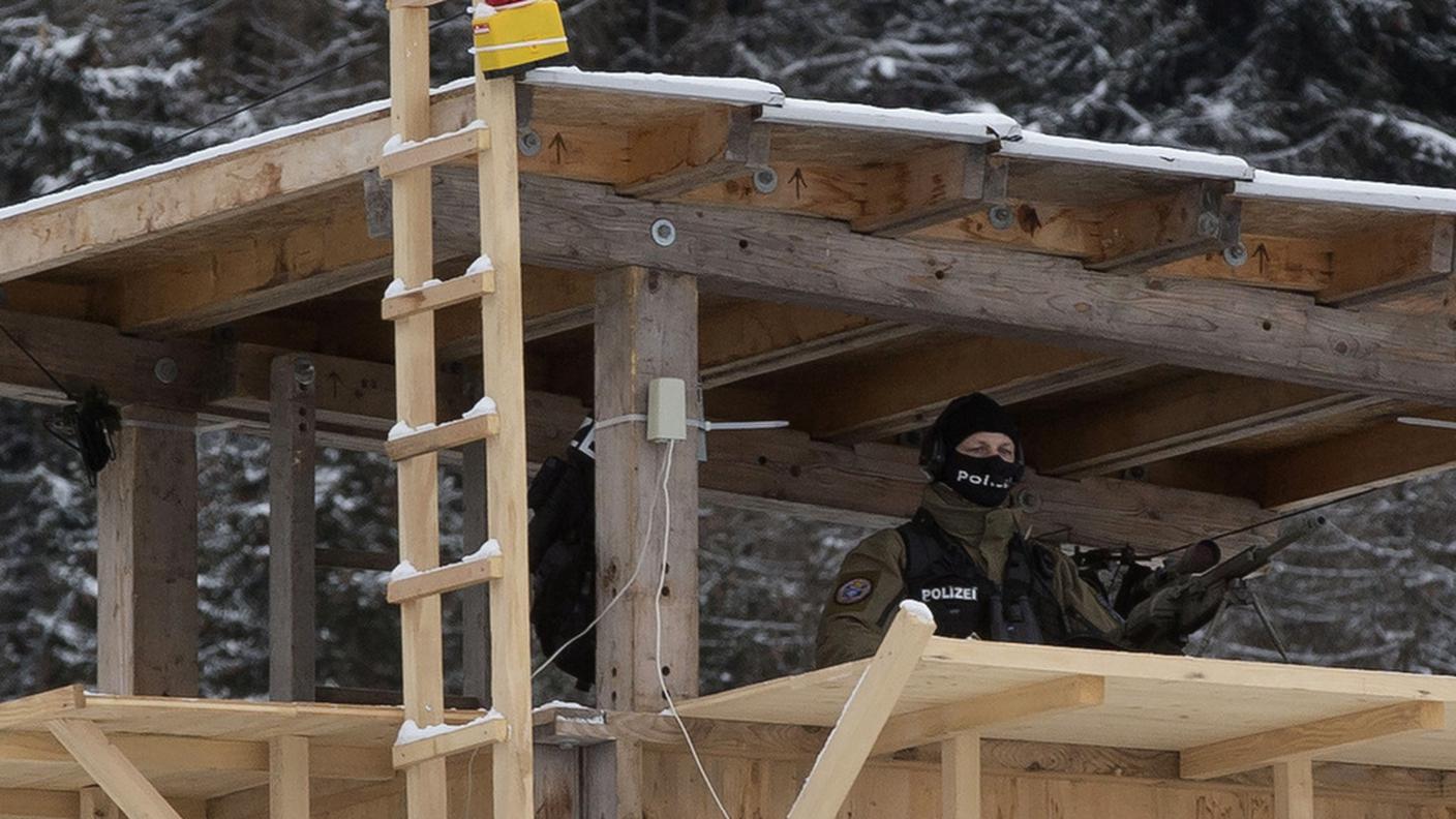 WEF A Swiss police officer stands guard at the entrance of a civilian heliport in Davos, ky.JPG
