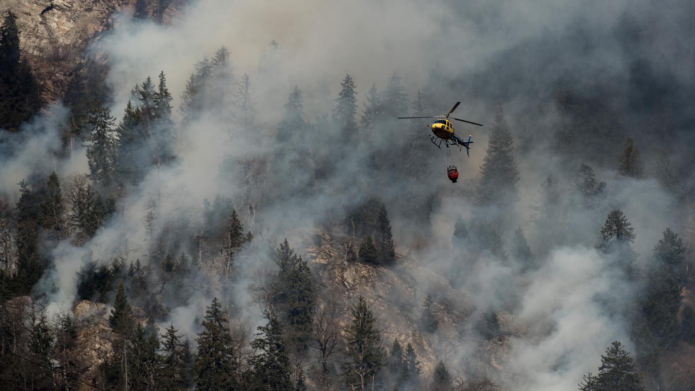 Un elicottero antincendio al lavoro sul bosco sopra Mesocco