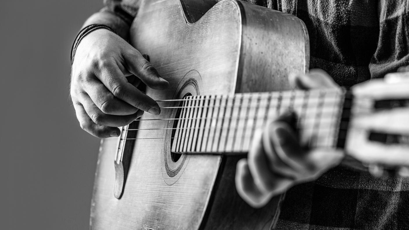 Close up hand playing guitar