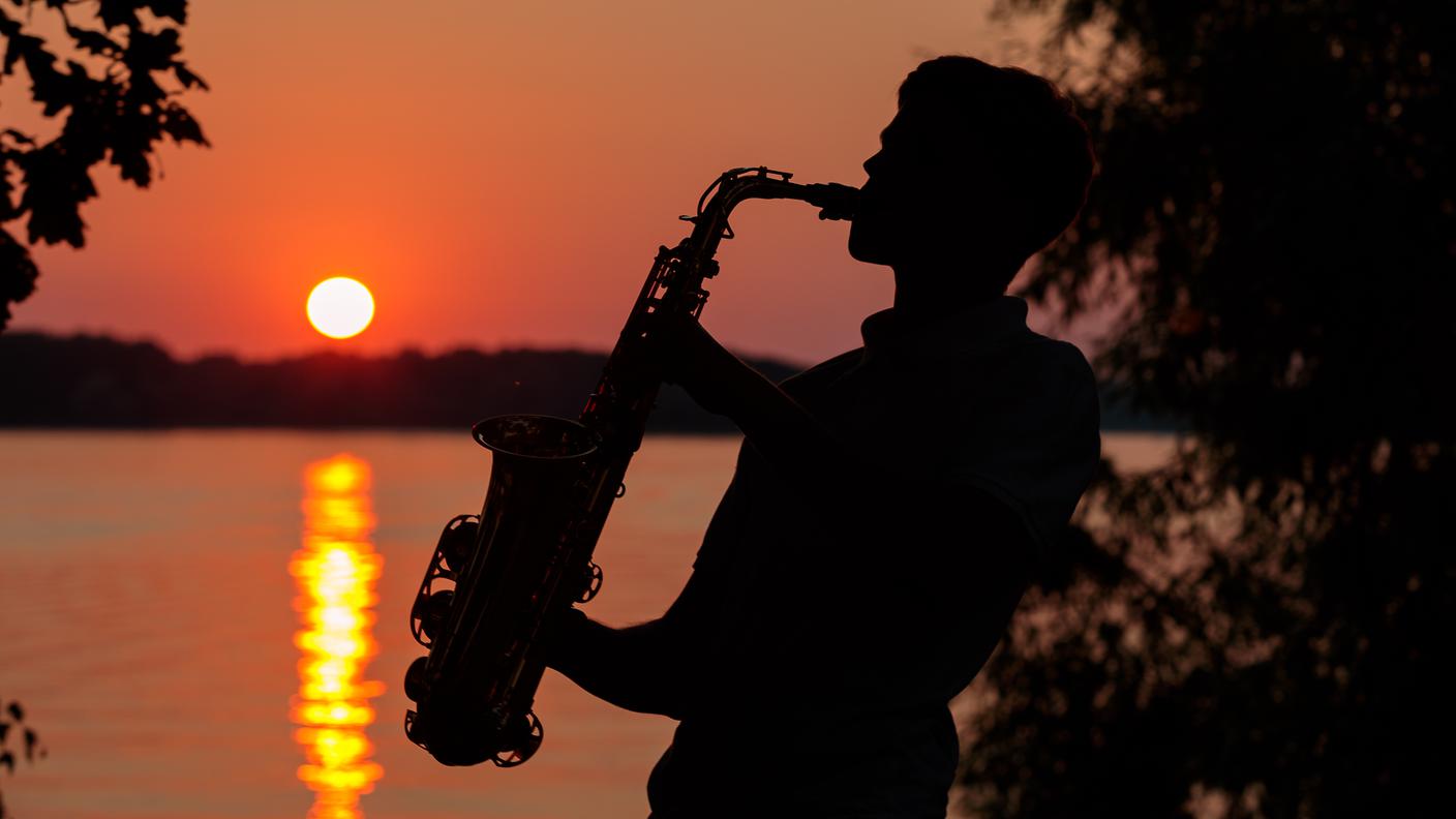 Man playing the Saxophone at sunset