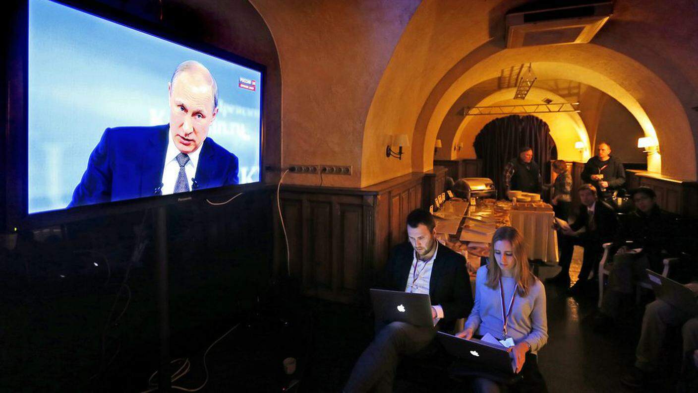 ky_Journalists watch the televized speech of Russian President Vladimir Putin on TV screens in press center during the broadcast of President Vladimir Putin's televised Q&A.JPG