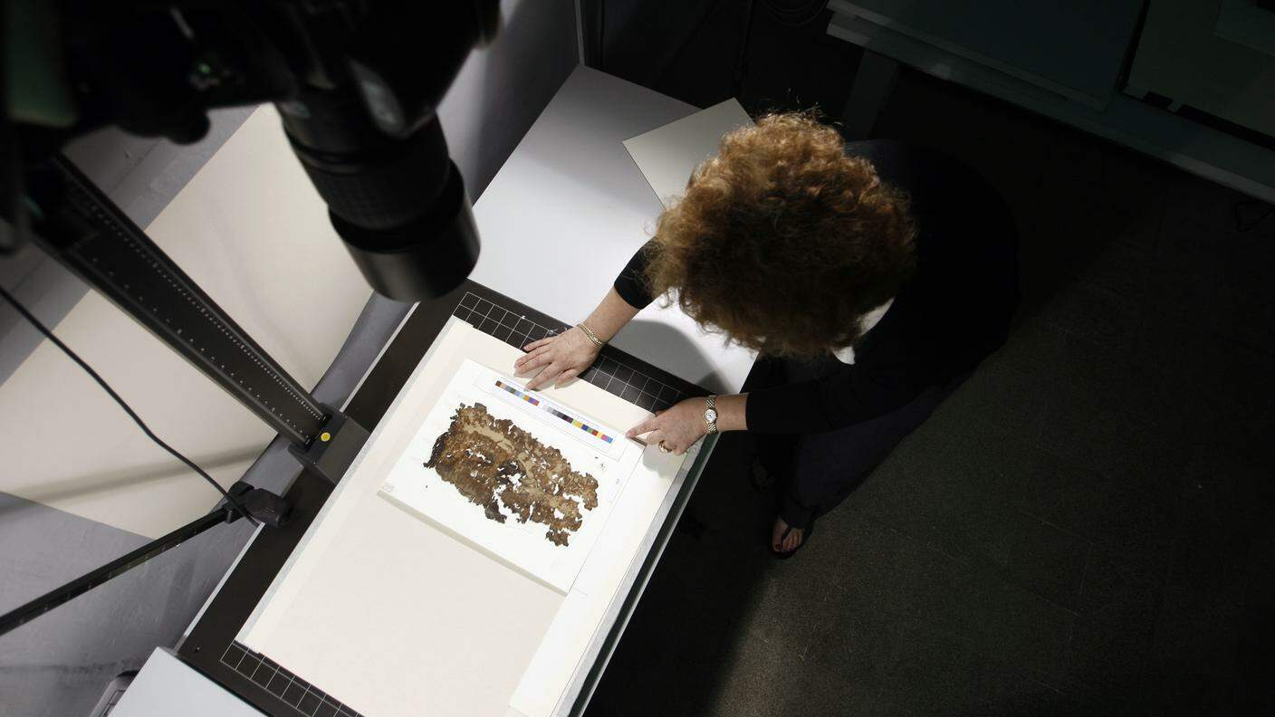 Reuters_Fragments of the Dead Sea scrolls are placed under a camera.jpg
