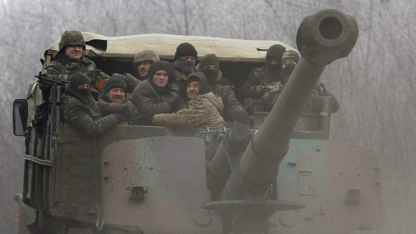 Ky_Ukrainian government soldiers ride on a vehicle on the road between the towns of Dabeltseve and Artemivsk, Ukraine, Saturday, Feb. 14, 2015.JPG