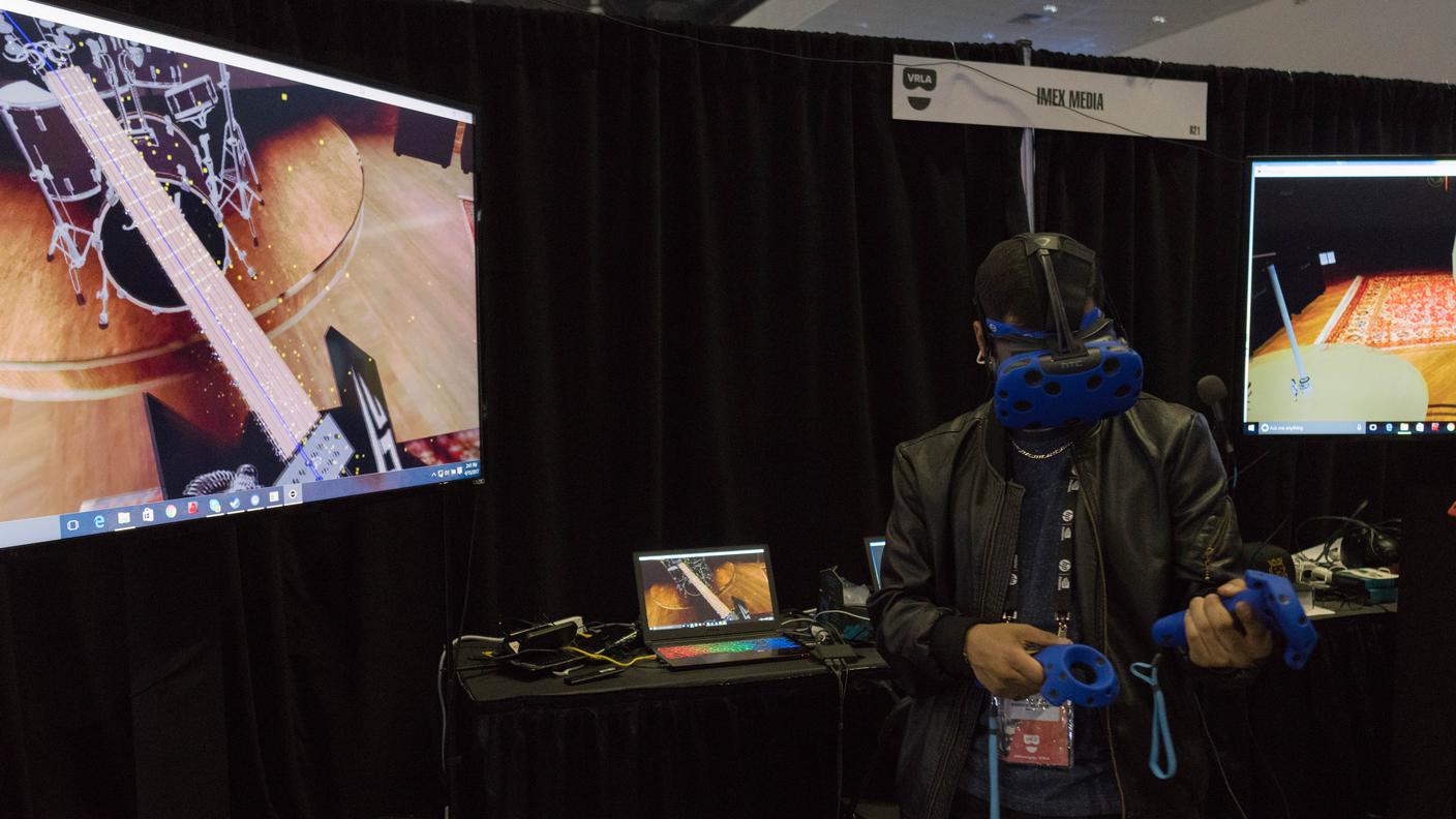 Man plays guitar in a virtual reality glasses