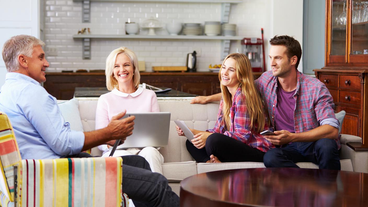 Genitori con Prole adulta utilizzando dispositivi digitali in casa